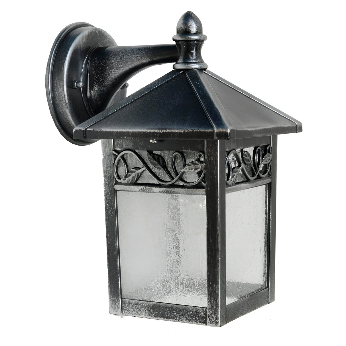 Introducing the Winchcombe 1 Light Outdoor Wall Lantern in black, a vintage-style lighting fixture constructed from cast aluminum. It features a square, glass-enclosed design adorned with decorative leaf detailing. This IP44 rated lantern has a pointed top and is mounted on a curved arm with a circular base.
