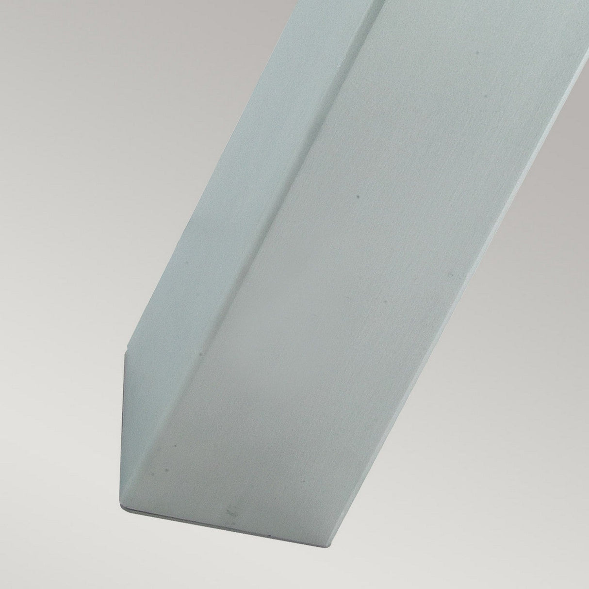 Close-up of the Halmstad Large Bollard - Silver, showcasing its rectangular cross-section and sharp, pointed end. Made from galvanized steel, the surface appears smooth and polished in a light gray color. The background features a plain, gradual gradient.