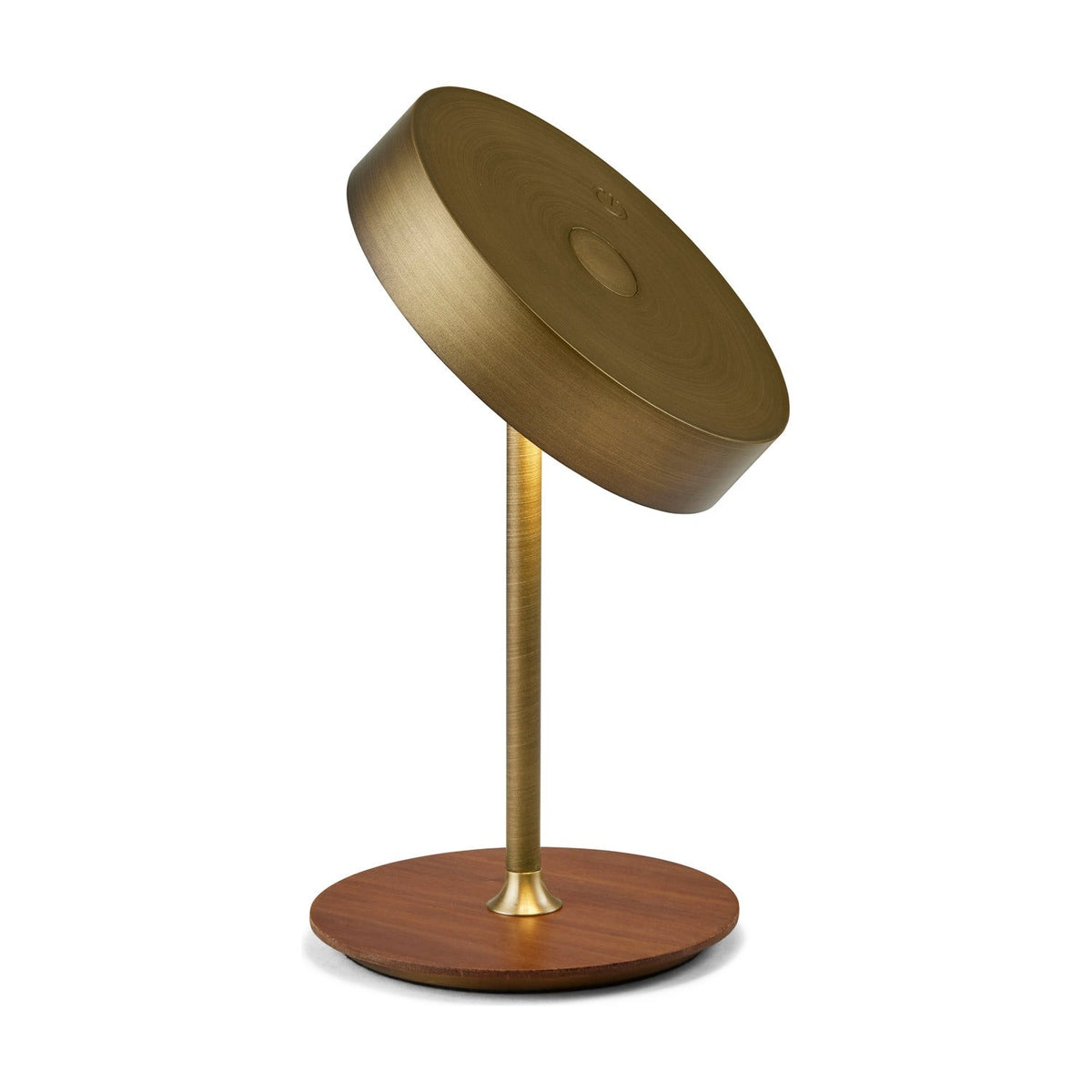 On the Move LED rechargeable table lamp with tilted antique brass drum shade on a slim brass stem and round walnut wood base, plain white background.