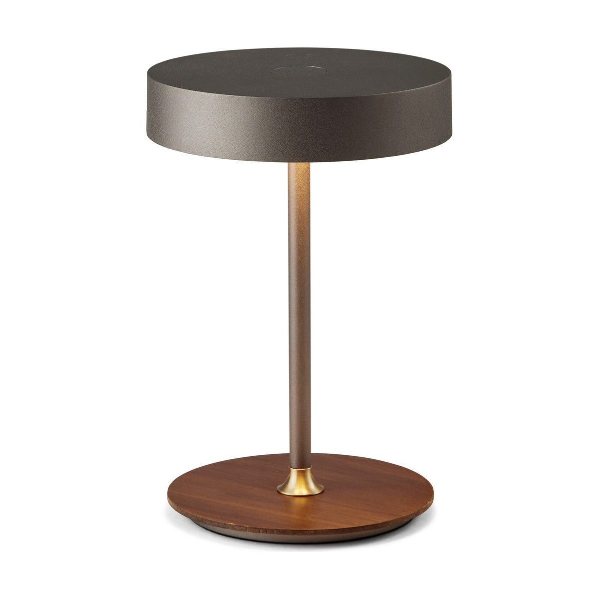 On the Move LED Rechargeable Table Lamp in gunmetal, with a round drum shade, slim stem, brass collar, and walnut disc base, shown on a plain white background.