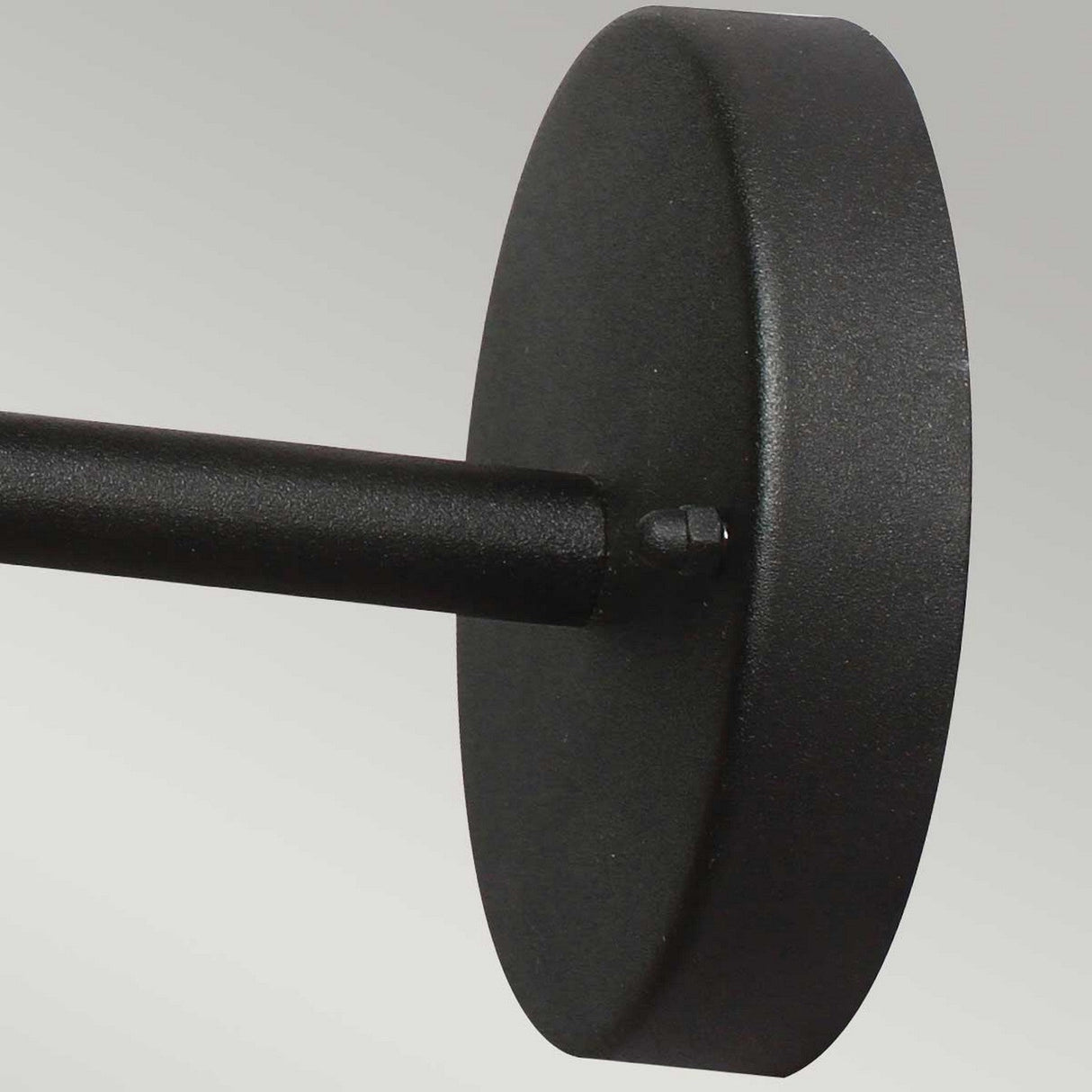 The Helsingor 1 Light Outdoor Wall Light - Black showcases a Danish-inspired design with a close-up of its matte black metal rod connected to a circular wall mount against a light gray background, exuding elegance and style.