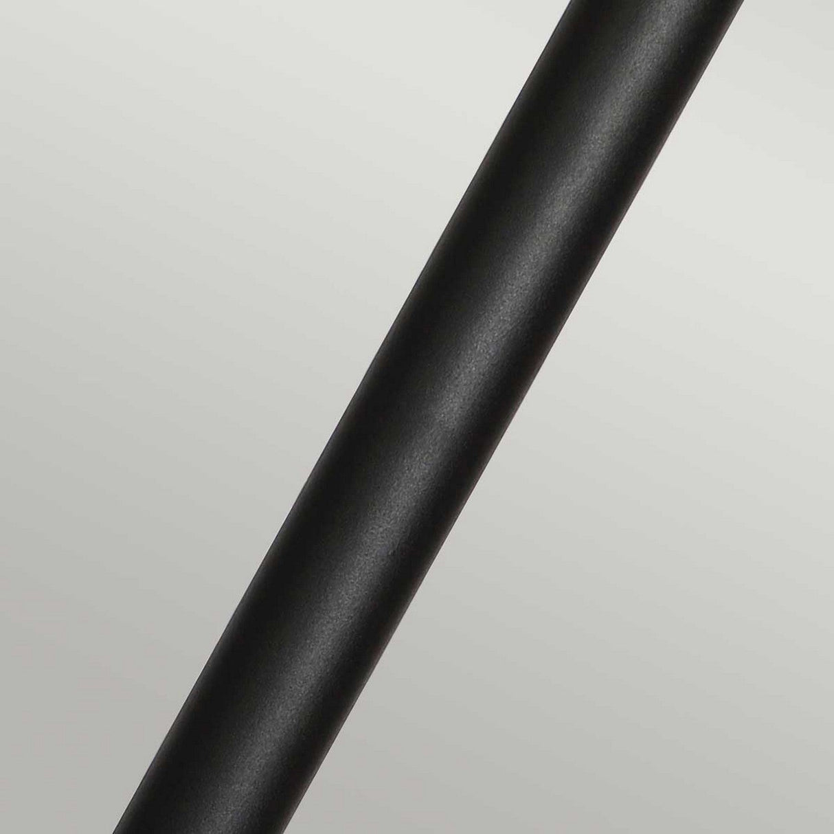 A close-up of the Helsingor 1 Light Bollard Lantern in sleek black, positioned diagonally against a light gray background.