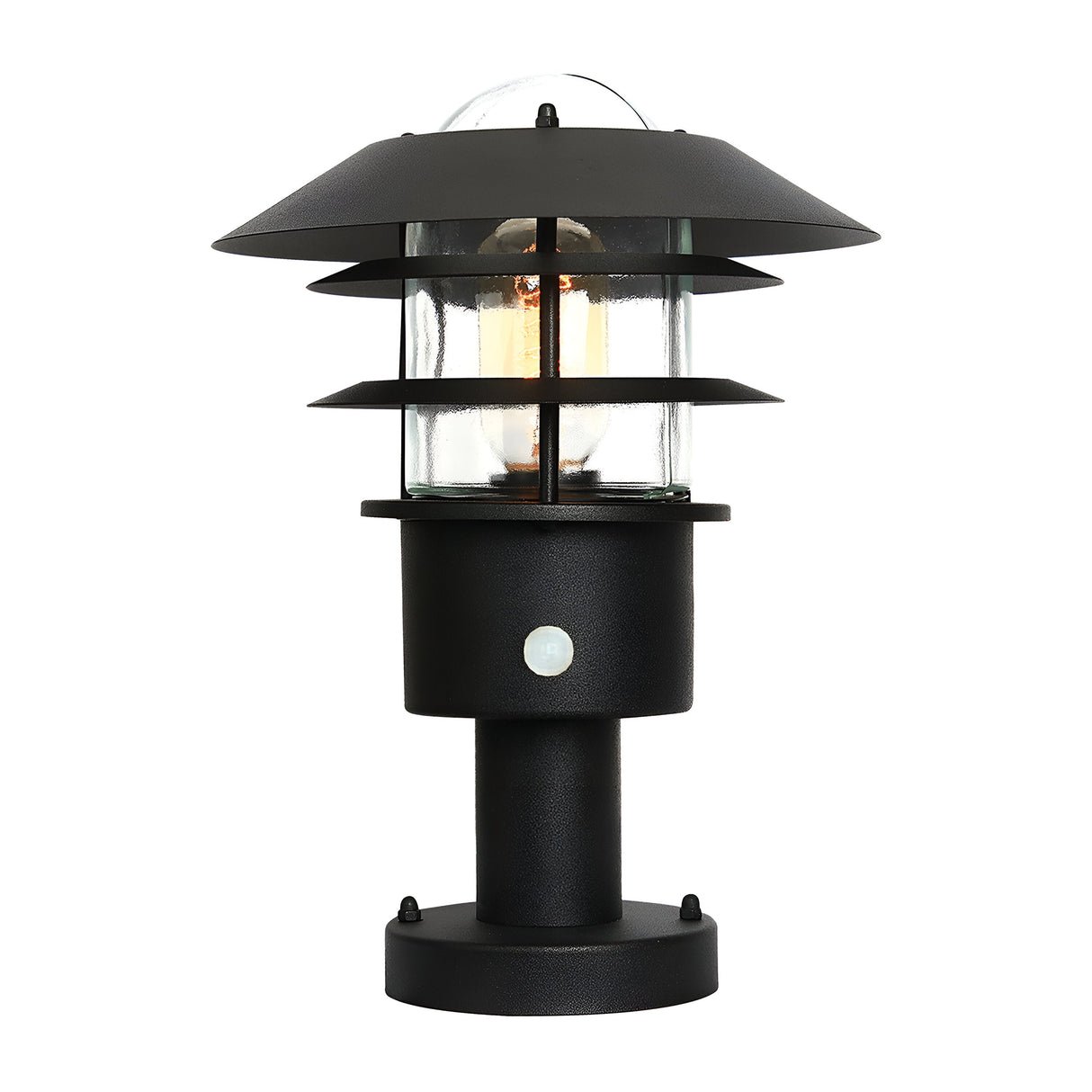 The Helsingor 1 Light PIR Pedestal Light in black has a modern design with a cylindrical base, glass enclosure, and layered circular metal shades. Its visible bulb through the clear glass enhances its aesthetic on a white background, perfectly balancing style with security lighting functionality.