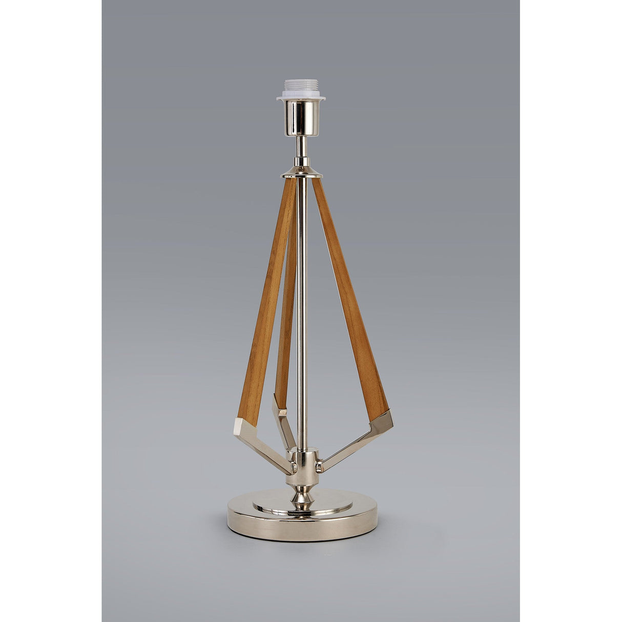 The Hilton 1 Light Wood Table Lamp - Nickel features a modern design with a circular nickel base and top, three angled wooden supports converging at the socket, and is shown without a lampshade against a plain grey background.