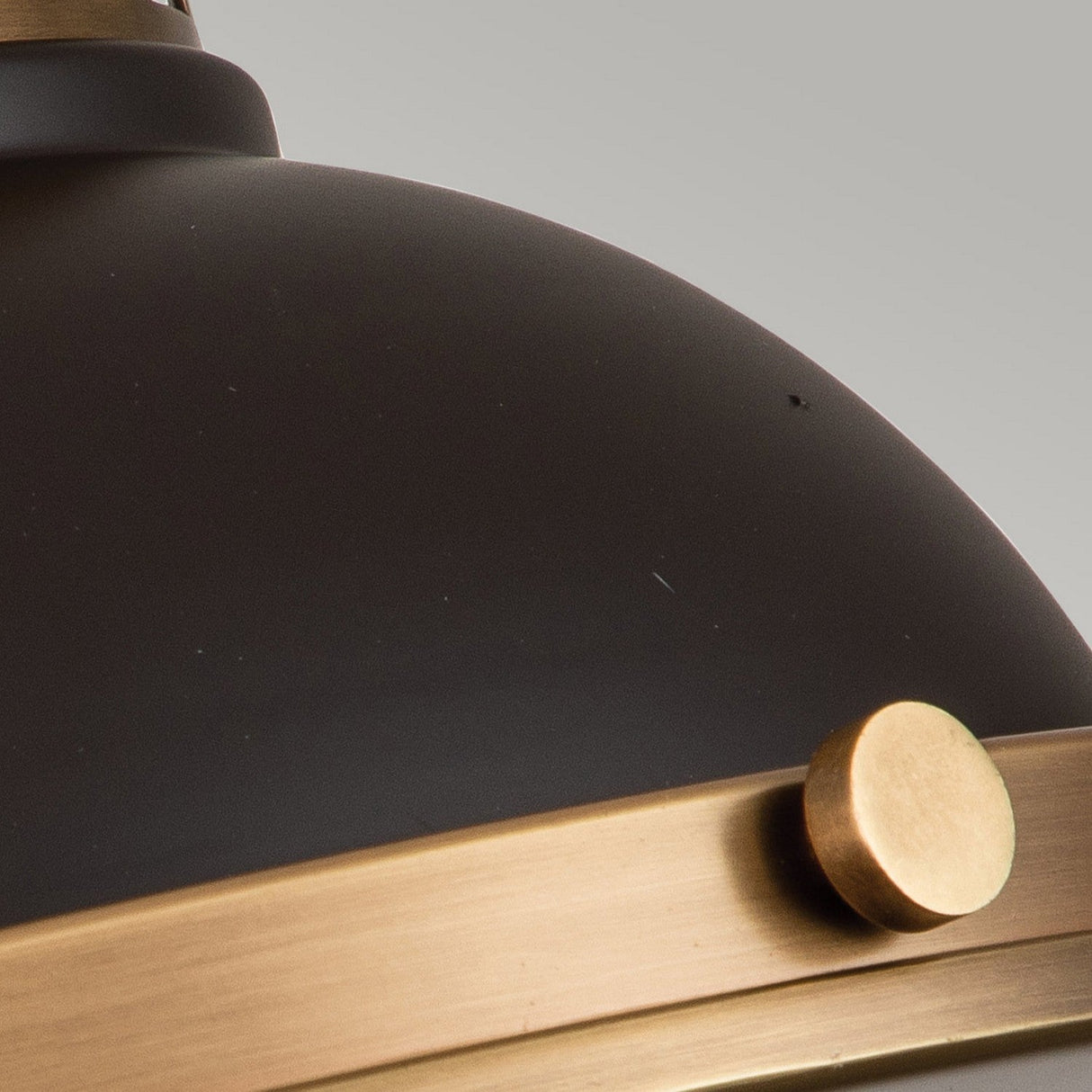The elegant Amelia 2 Light Flush Light - Bronze features a smooth, dome-shaped matte black finish with a brass accent band and circular knob. Its minimalist design is beautifully complemented by a cast glass diffuser against the gray background.