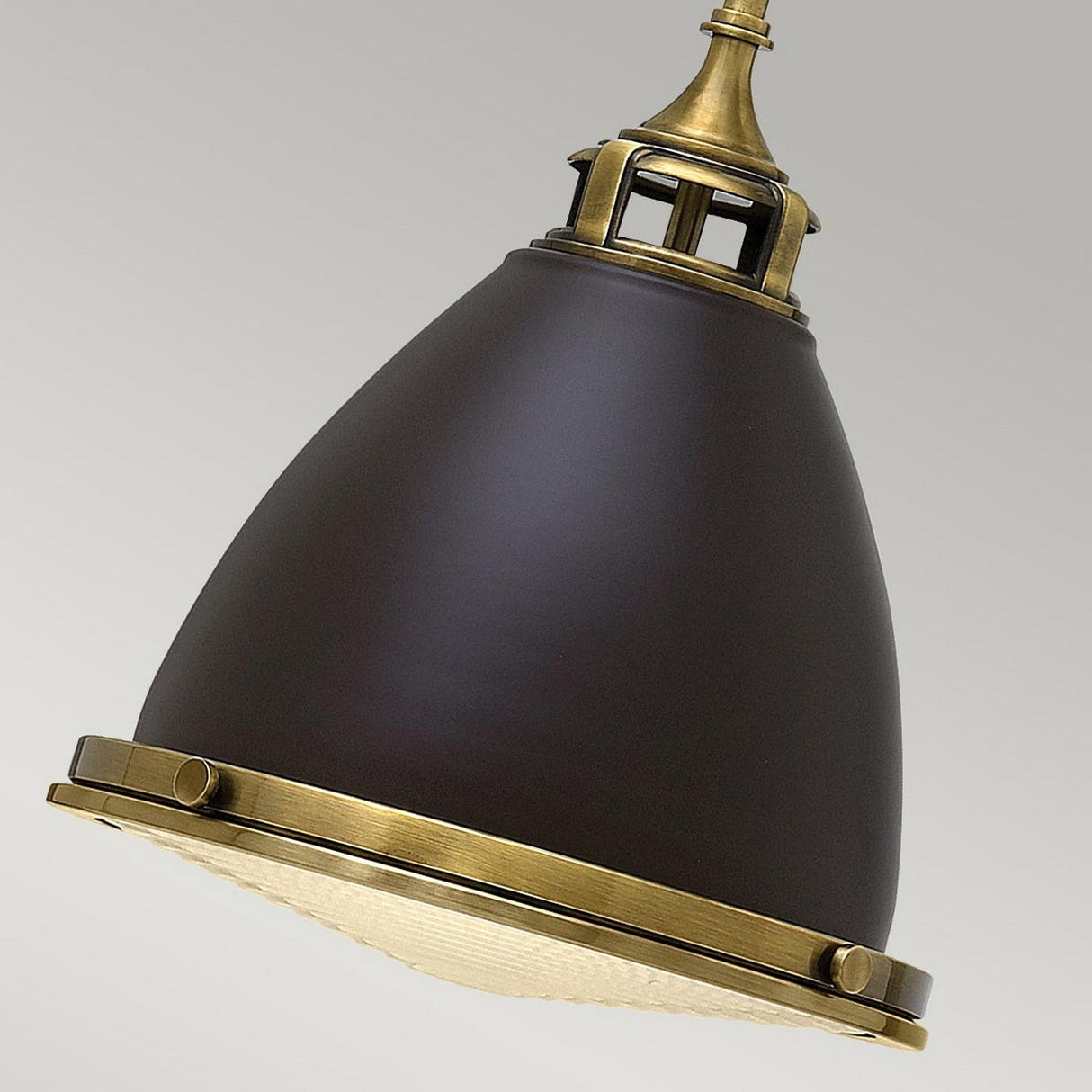 Close-up of the Amelia 1 Light Medium Pendant in a vintage style with a dark bronze finish, including a conical shade and an opal glass dome diffuser. The fixture's classic, industrial design hangs elegantly against a plain background, capturing timeless vintage aesthetics.
