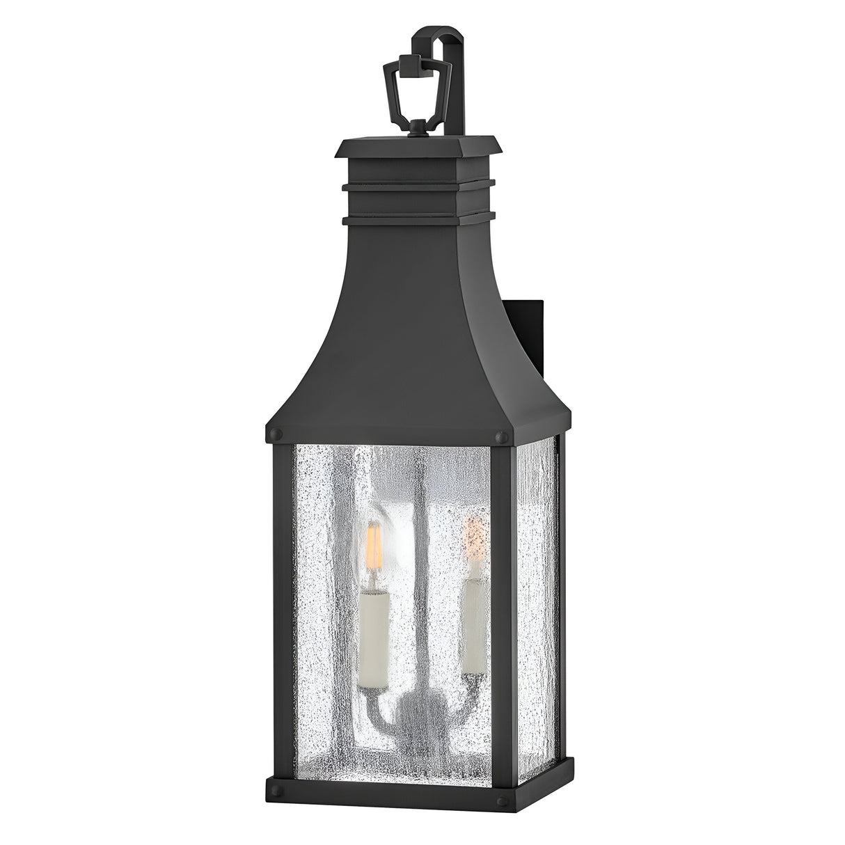 The Beacon Hill 2 Light Outdoor Medium Wall Lantern in Black features a classic design with a rectangular body and a peaked top, making it perfect for outdoor settings. Its textured glass panels elegantly encompass two candle-style bulbs, offering a timeless glow.