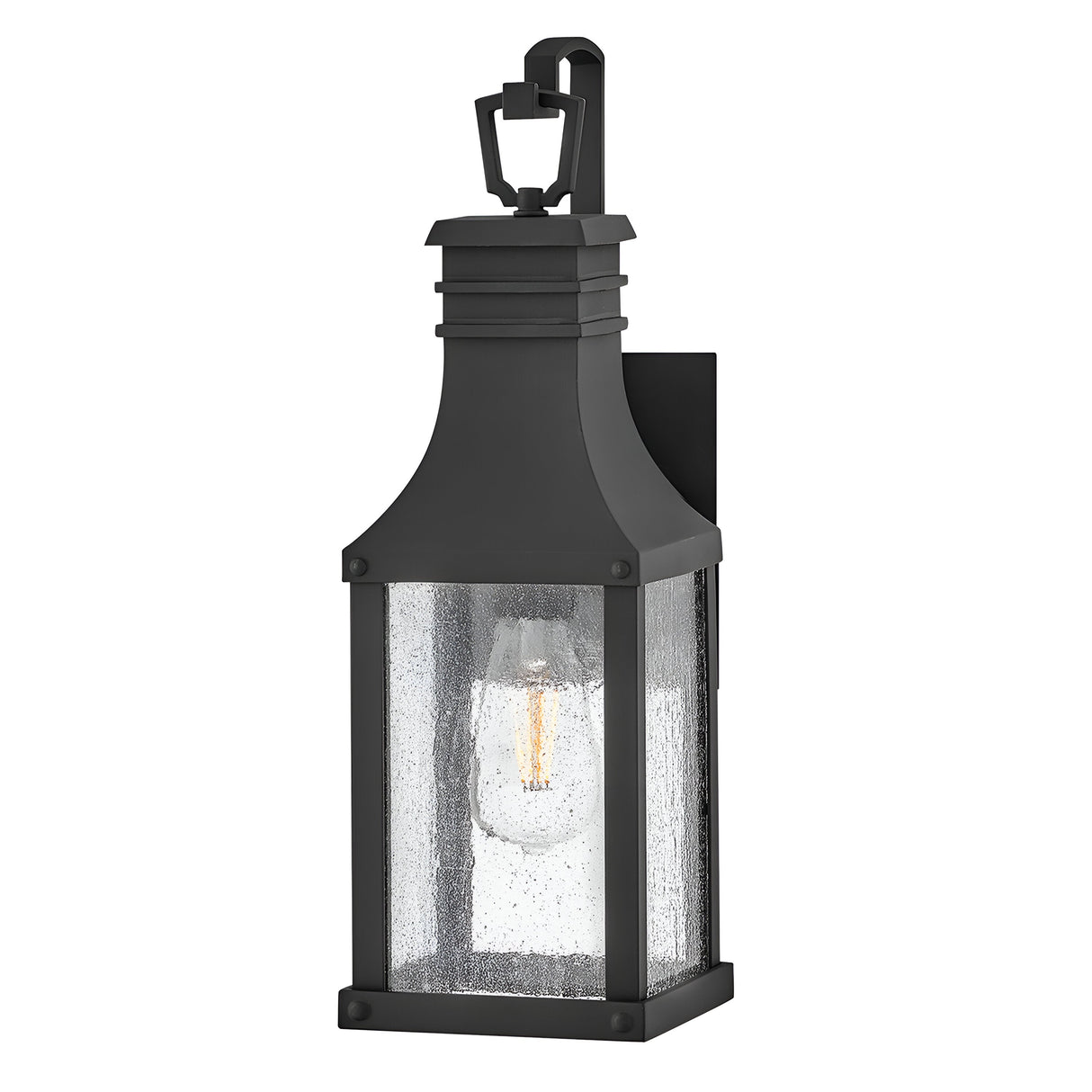 The Beacon Hill 1 Light Outdoor Small Wall Lantern in Black boasts a rectangular design with a clear seeded glass enclosure. Inside, it displays a single visible bulb and is elegantly topped with a decorative loop.