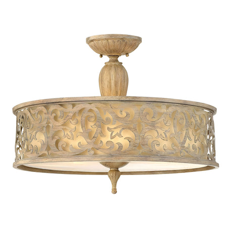 The Carabel 3 Light Large Semi Flush in a brushed champagne finish features an ornate, patterned metal exterior with intricate scrollwork. It emits a warm glow through its translucent diffuser at the bottom, making it perfect for your semi flush lighting needs.
