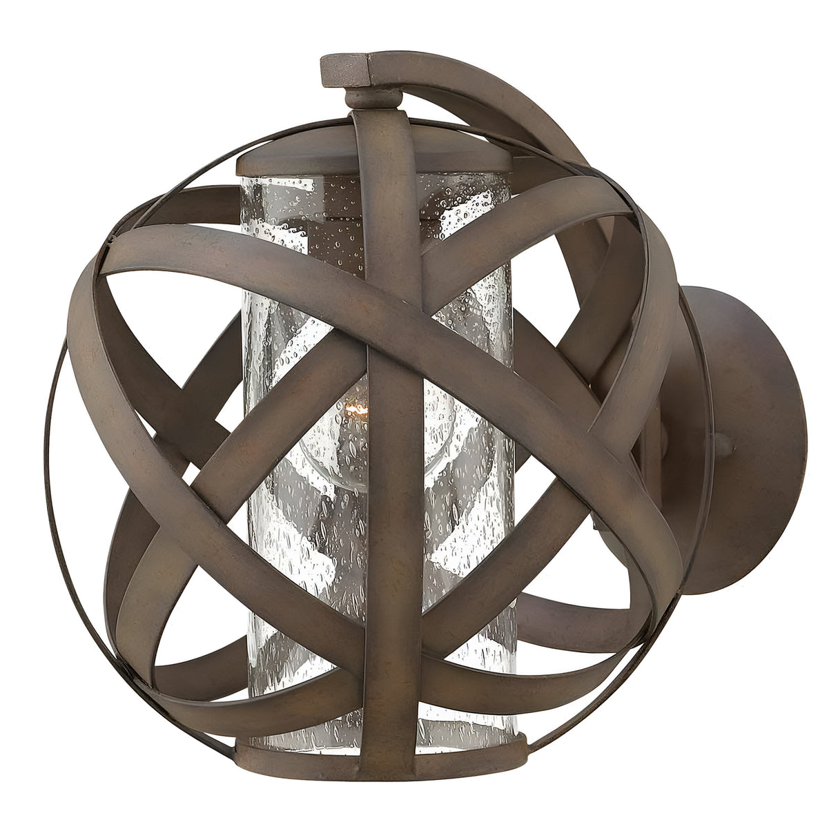The Carson 1 Light Outdoor Small Wall Lantern in Vintage Iron boasts a handcrafted design, featuring a spherical frame with intersecting metal bands surrounding a seeded glass cylinder that houses the bulb.