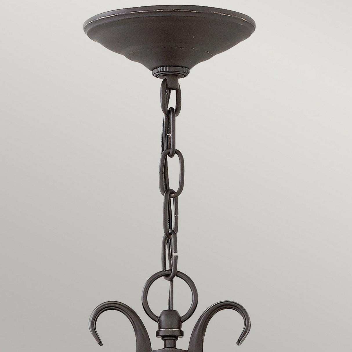 Close-up of the Casa 3 Light Outdoor Chain Lantern in black, featuring a sleek metal ceiling mount and chain. The chain links, adorned with intricate pierced metalwork, seamlessly connect to a decorative hook, extending downward against a neutral background.