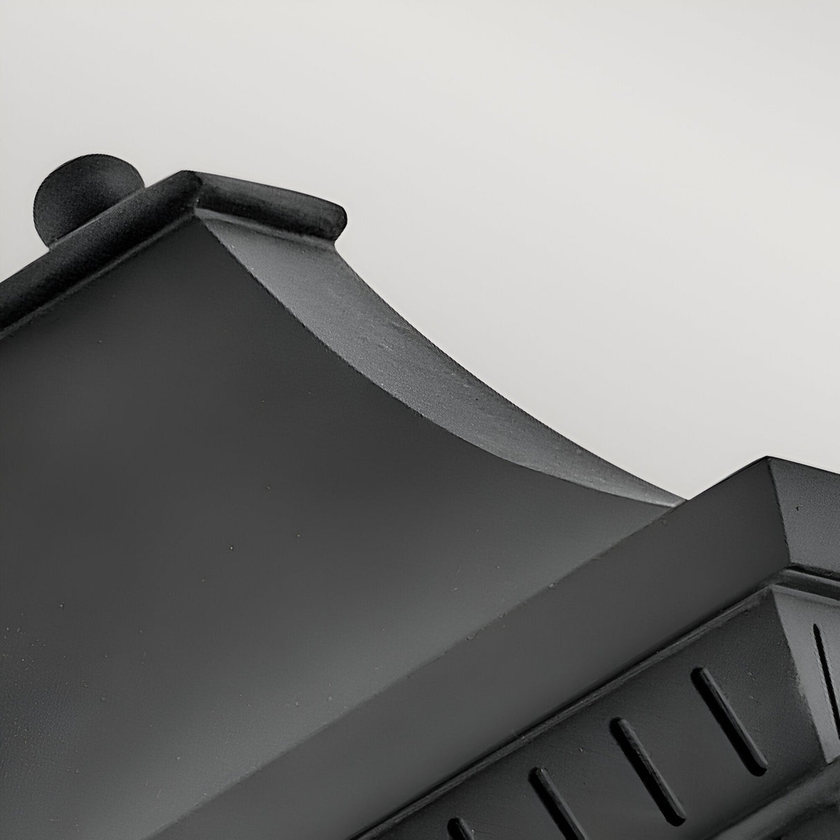 Close-up of the Chapel Hill 2 Light Outdoor Half Wall Lantern in black, featuring a curved roof and sleek lines, set against a plain light grey background.