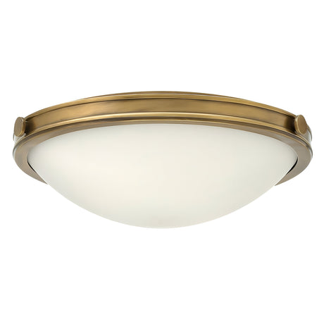 The Collier 3 Light Large Flush - Heritage Brass showcases a Heritage Brass finish along with a white vintage glass dome shade, delivering timeless elegance.