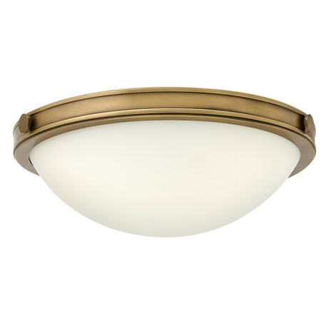 The Collier 2 Light Small Flush - Heritage Brass boasts a round, dome-shaped design with a frosted glass shade, highlighted by a metal rim in Heritage Brass. This chic flush mount light brings an elegant touch to any room.