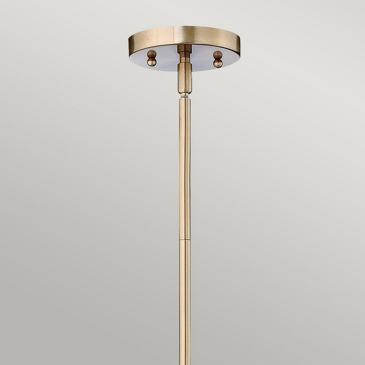 The Congress 1 Light Clear Glass Pendant with a cylindrical base and an adjustable rod, adorned with brushed caramel accents, is elegantly displayed against a plain gray background.