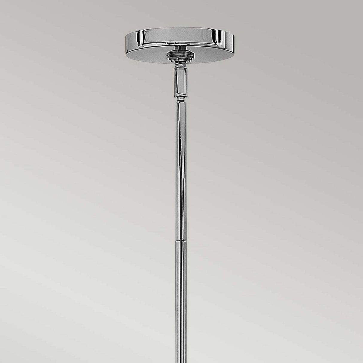 Close-up of the Congress 4 Light Clear Glass Chandelier in chrome against a grey background. The design highlights a round canopy and narrow rod, exuding modern elegance with its minimalist style and chrome finish.