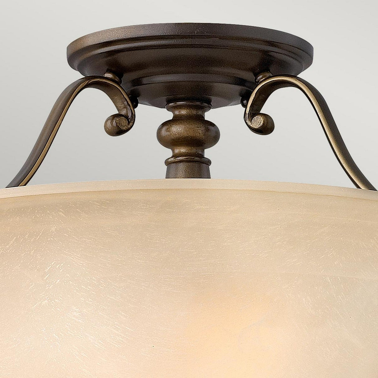 Close-up of the Dunhill 2 Light Semi Flush in bronze, featuring vintage-inspired glass shades. The elegant curves and classic style of this lighting fixture are highlighted against a neutral background.