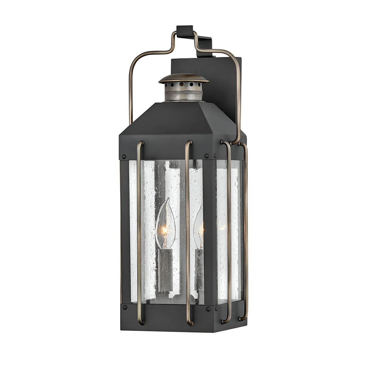 The Fitzgerald 2 Light Outdoor Medium Wall Lantern - Black With Burnished Bronze exudes industrial charm with its vintage-style design, featuring a dark metal frame and clear glass panels. Inside, you can see two visible candle-shaped lights. It is mounted on a rectangular backplate with a curved top handle, ensuring both style and durability as an IP44 rated outdoor light.
