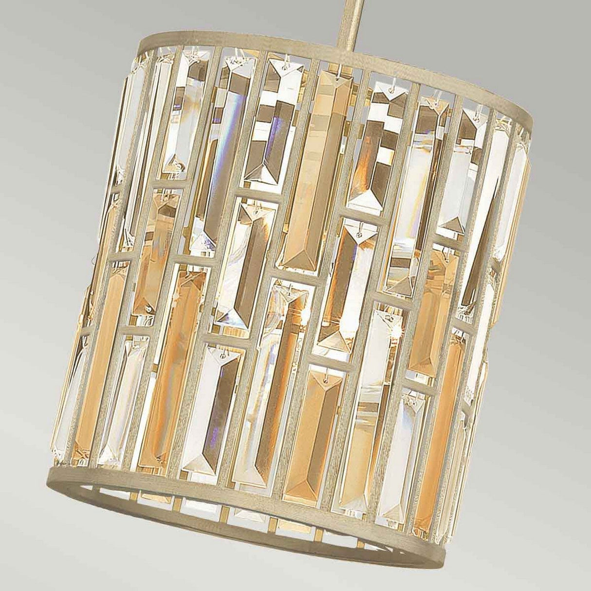 Close-up of the Gemma 1 Light Mini Pendant - Gold, showcasing a geometric design with vertical crystal prisms in a rectangular shape. The gold-finished crystals beautifully reflect warm light, offering an elegant and modern look that is both striking and sophisticated.