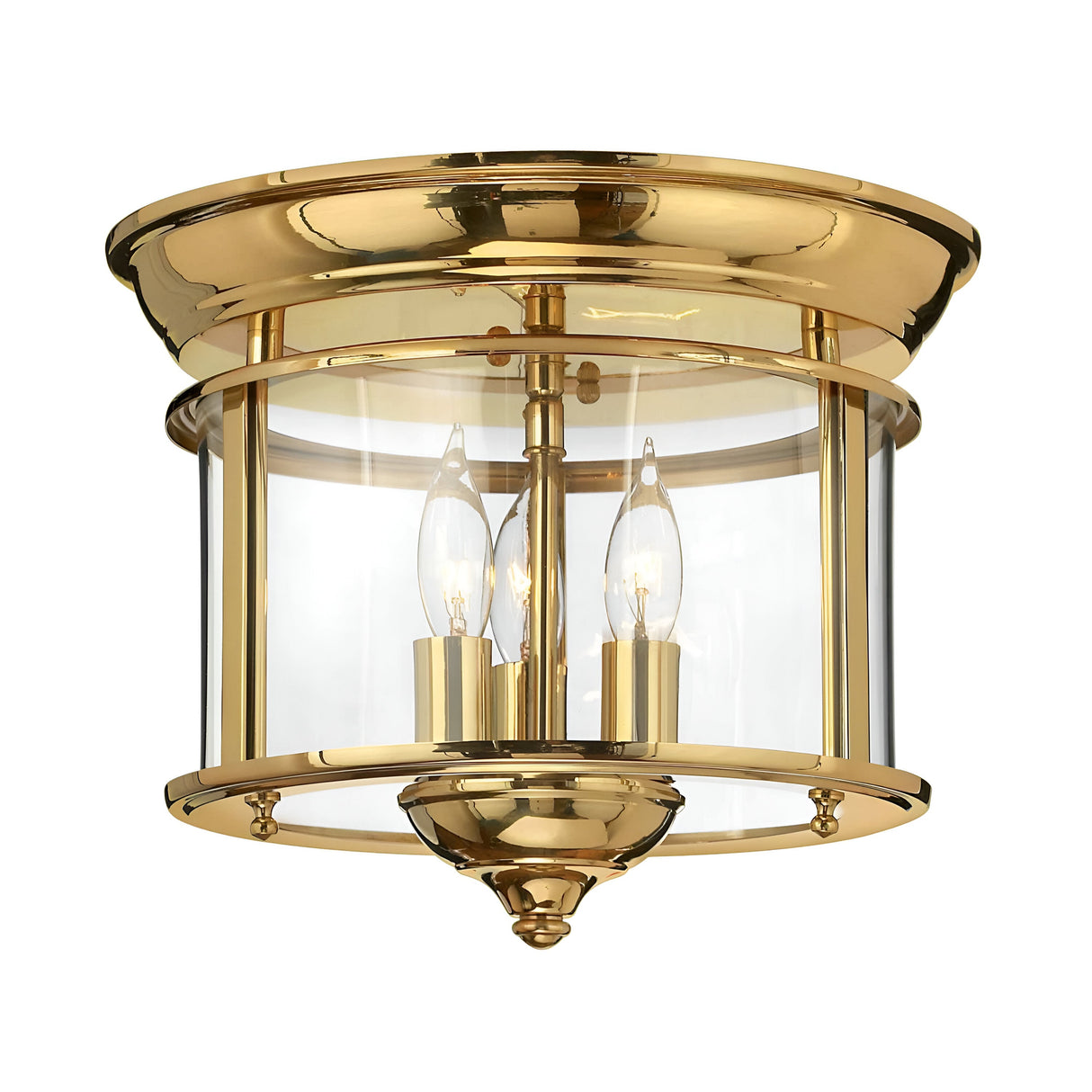The Gentry 3 Light Flush in polished brass boasts a gold finish with a semi-flush mount design, featuring a clear glass cylindrical shade and elegant brass elements. Inside, it accommodates two candle-style bulbs, seamlessly blending traditional style with modern elegance to enhance any interior space with sophistication.