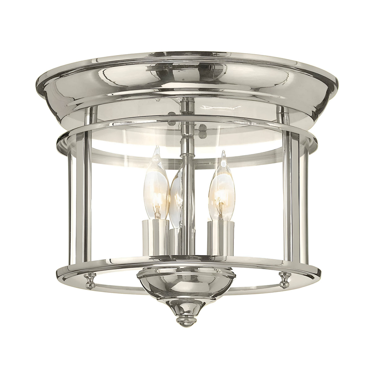 The Gentry 3 Light Flush - Polished Nickel ceiling fixture showcases a polished nickel finish that complements its circular design. With a clear glass enclosure housing three candle-style bulbs, it seamlessly blends traditional design elements with a sleek, modern aesthetic.