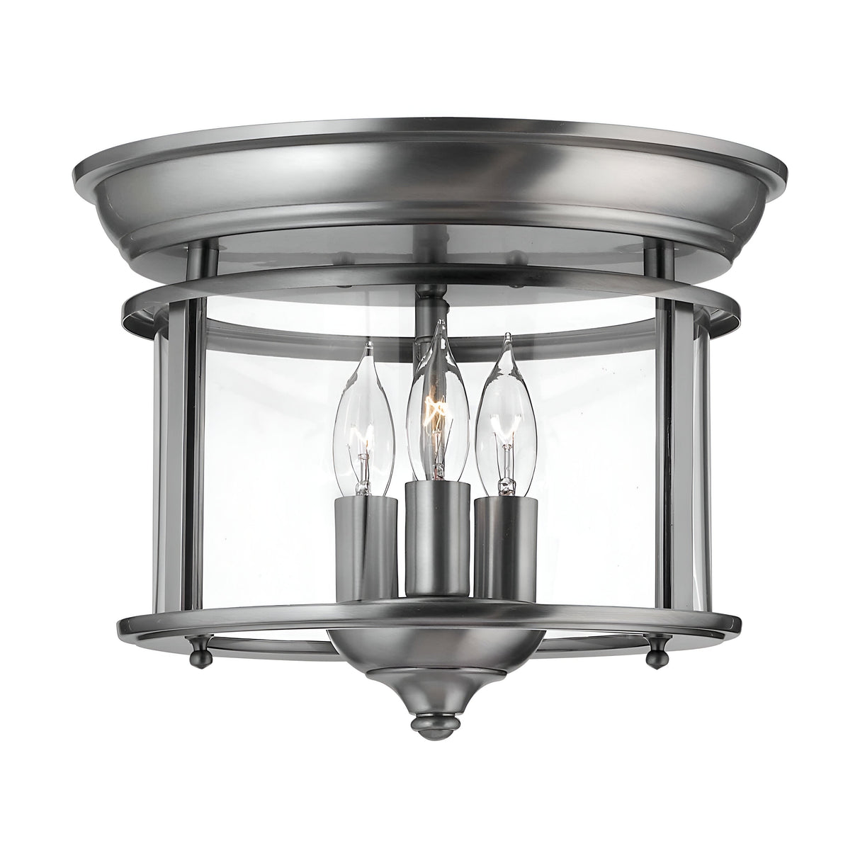 Introducing the Gentry 3 Light Flush - Silver, a modern ceiling light fixture featuring a sleek silver finish and clear glass panels. This flush mount light elegantly illuminates with three candle-style bulbs, making it a perfect complement to contemporary interiors with its streamlined design.