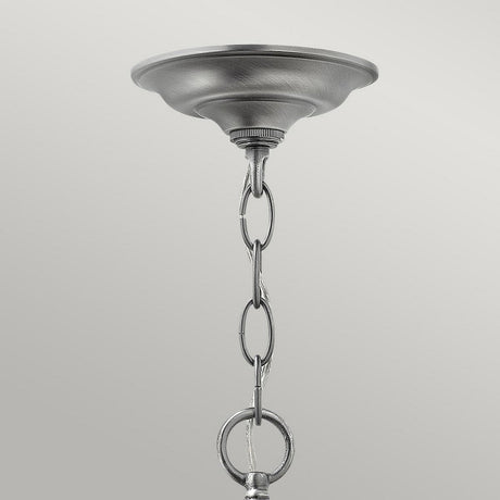 A close-up image displays the Gentry 6 Light Large Pendant - Silver with its sleek, metallic ceiling canopy and a chain of interlinked oval rings hanging down. The contemporary lighting fixture is designed in a circular, slightly domed shape reminiscent of a silver pendant, set against a plain, light gray background.