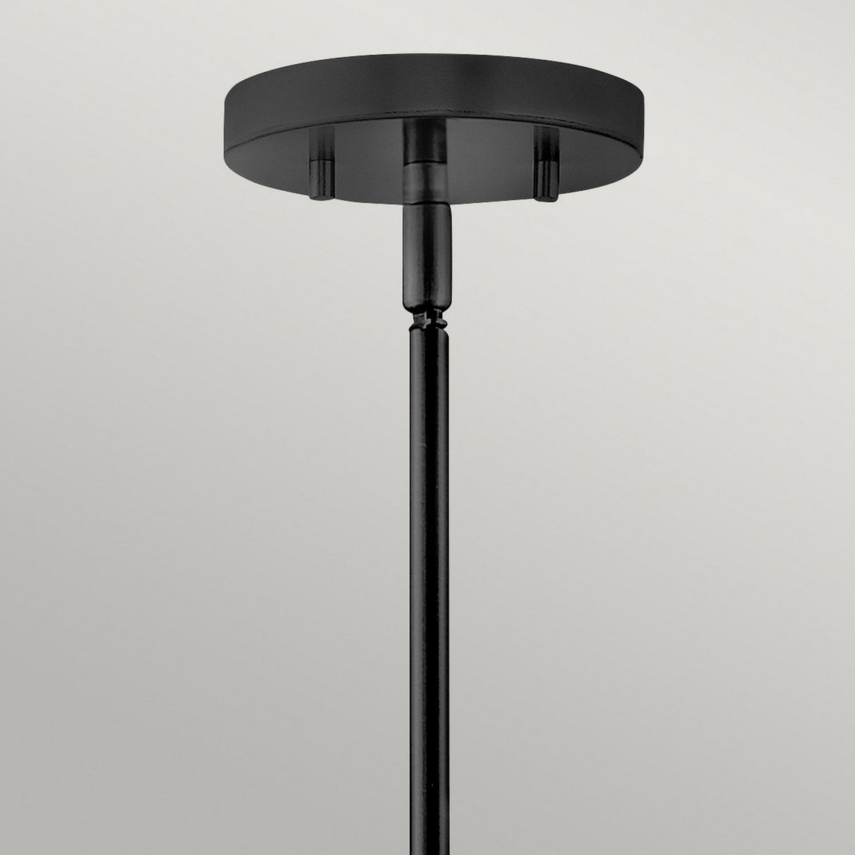 A close-up view of the Graham 4 Light Duo-Mount Pendant/Semi-Flush in black shows its classic charm with a round base. This fixture extends vertically downwards against a plain, light background, seamlessly blending elegance and functionality.