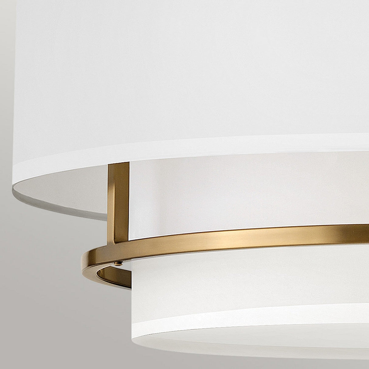 Here's a rewritten version of the sentence using the provided product data:
Close-up of the Graham 4 Light Duo-Mount Pendant/Semi-Flush - Lacquered Brass, a contemporary ceiling light fixture showcasing overlapping white circular shades with polished brass accents. This minimalist design exudes sophistication against a neutral backdrop.