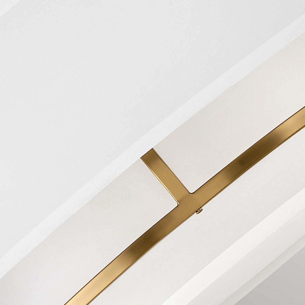 Close-up of a modern ceiling design featuring curved white panels with a sleek, intersecting metallic gold accent. The minimalist architecture, enhanced by the Graham 4 Light Duo-Mount Pendant/Semi-Flush in lacquered brass, creates a sophisticated and elegant appearance.