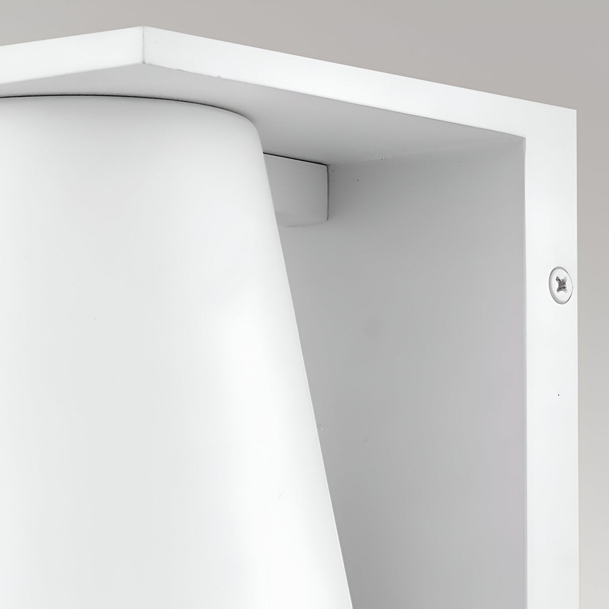 Close-up of the Coastal 1 Light Small Outdoor Wall Lantern in textured white, featuring a rectangular frame and curved inner surface, mounted on a light grey wall—ideal for enhancing coastal outdoor spaces.