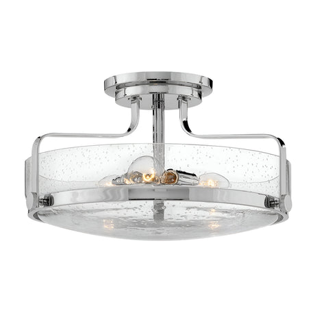 The Harper 3 Light Medium Semi Flush features a polished chrome finish and clear seeded glass shade, complete with a subtle bubble texture. It elegantly houses four exposed bulbs, adding a modern and sophisticated touch to any space.