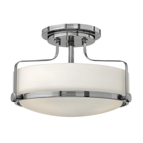 Introducing the Harper 3 Light Small Semi Flush, a contemporary ceiling light fixture with a sleek design. It features a round, opal etched glass shade paired with polished chrome metal supports, offering a smooth and reflective structure perfect for modern interiors.