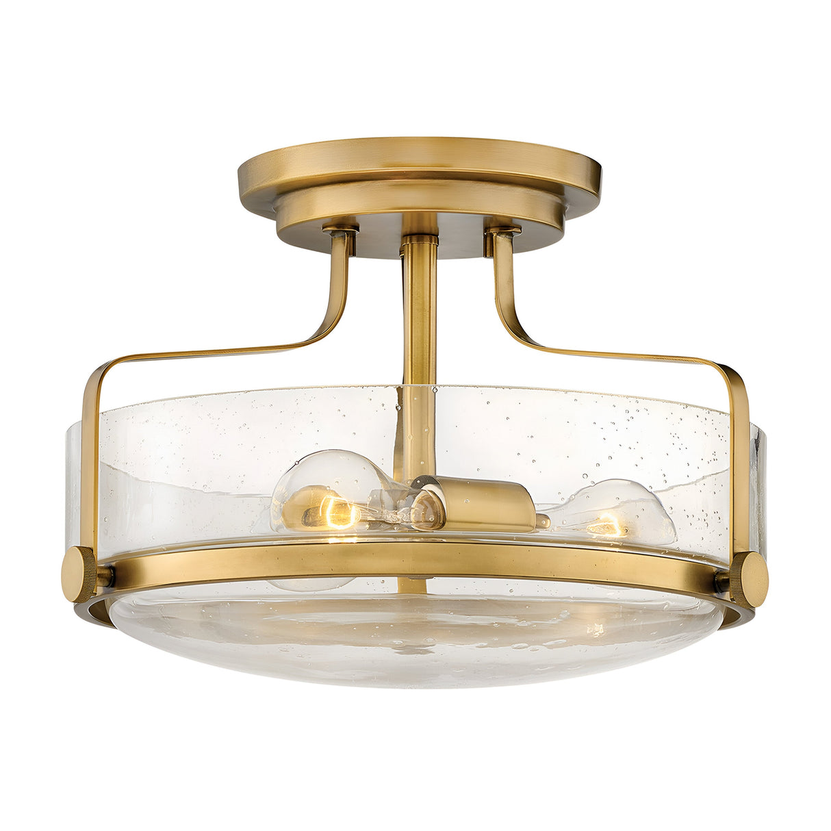 The Harper 3 Light Small Semi Flush in Heritage Brass features two exposed bulbs and a clear seeded glass shade with subtle speckles, mounted on a short brass stem.