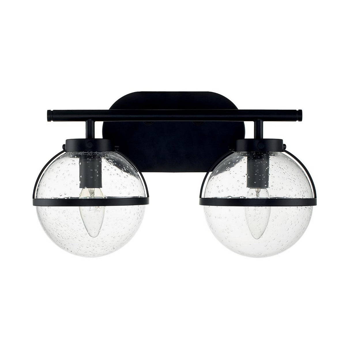 The Hollis 2 Light Wall Light - Black With Clear Glass is a modern fixture with two clear, spherical glass shades that have a bubble texture. These shades, reminiscent of Art Deco lighting style, are mounted on a sleek black metal frame attached to a wall plate.