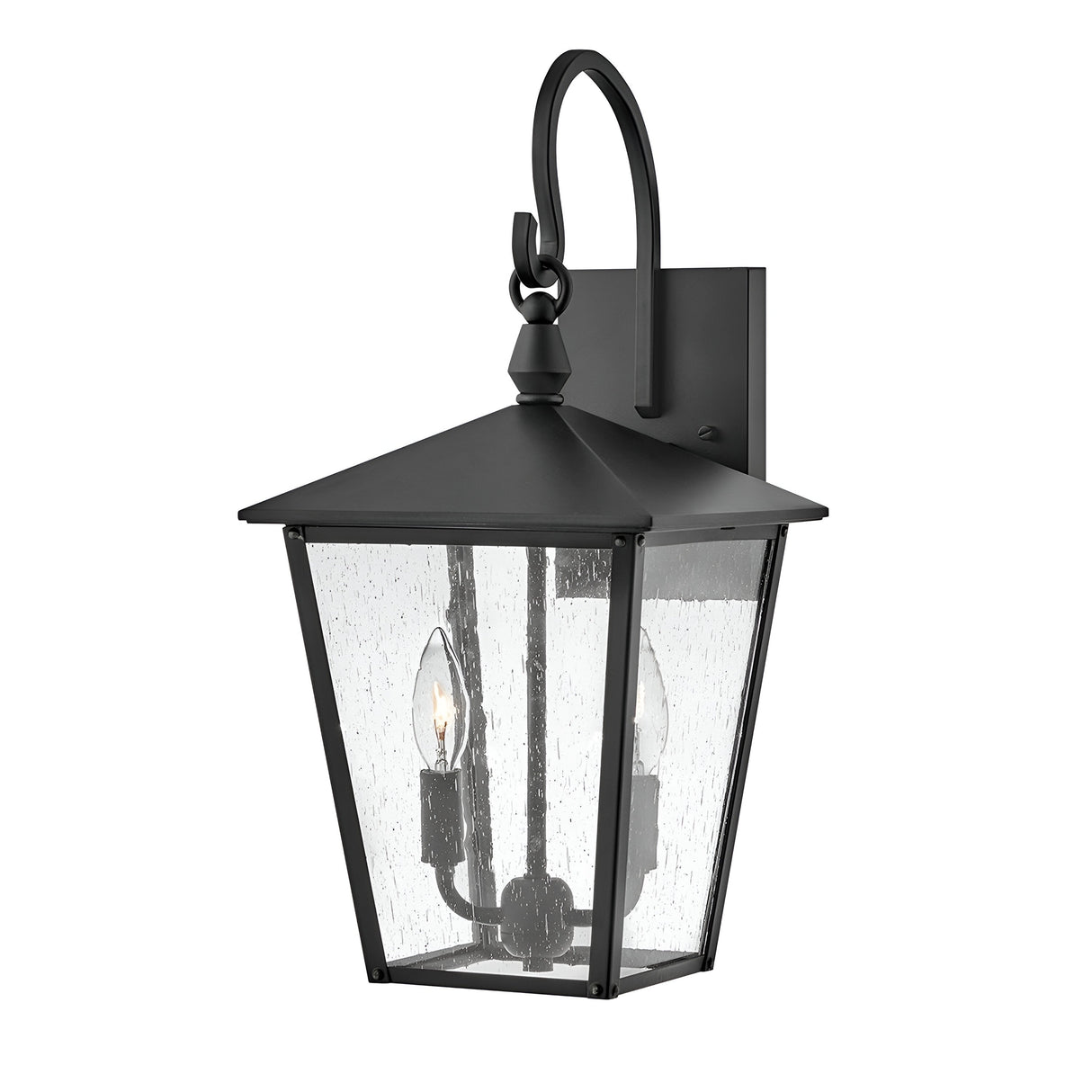 The Huntersfield Outdoor 2 Light Medium Wall Lantern in black showcases a sleek pointed roof and clear glass panels. It includes a curved hook for effortless mounting and features two candle-shaped light bulbs, providing elegant outdoor lighting with its stylish black finish.