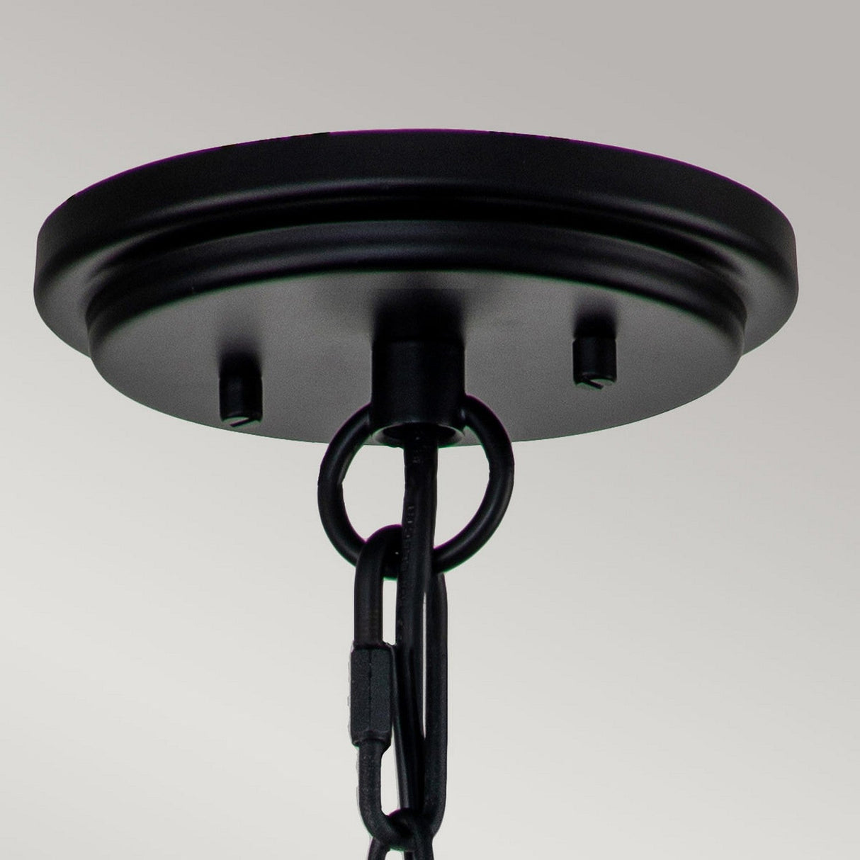Close-up of the black ceiling canopy from the Huntersfield Outdoor 3 Light Large Chain Pendant, featuring a chain reminiscent of a black finish lantern, set against a light gray background. The chain is centrally attached to the round canopy, ideal for suspending outdoor pendant lights or chandeliers.