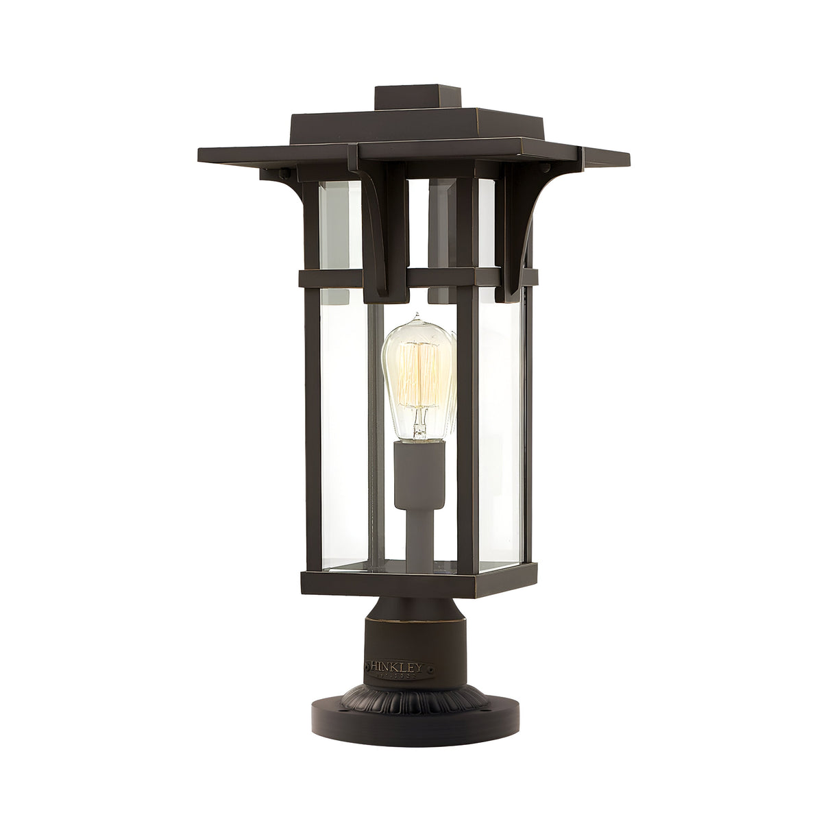 The Manhattan Outdoor 1 Light Pedestal in oil-rubbed bronze boasts a modern design with clear glass panels that highlight a filament bulb. It has an IP44 rating and features a rectangular shape on a sturdy base, offering both elegance and durability for your outdoor space.