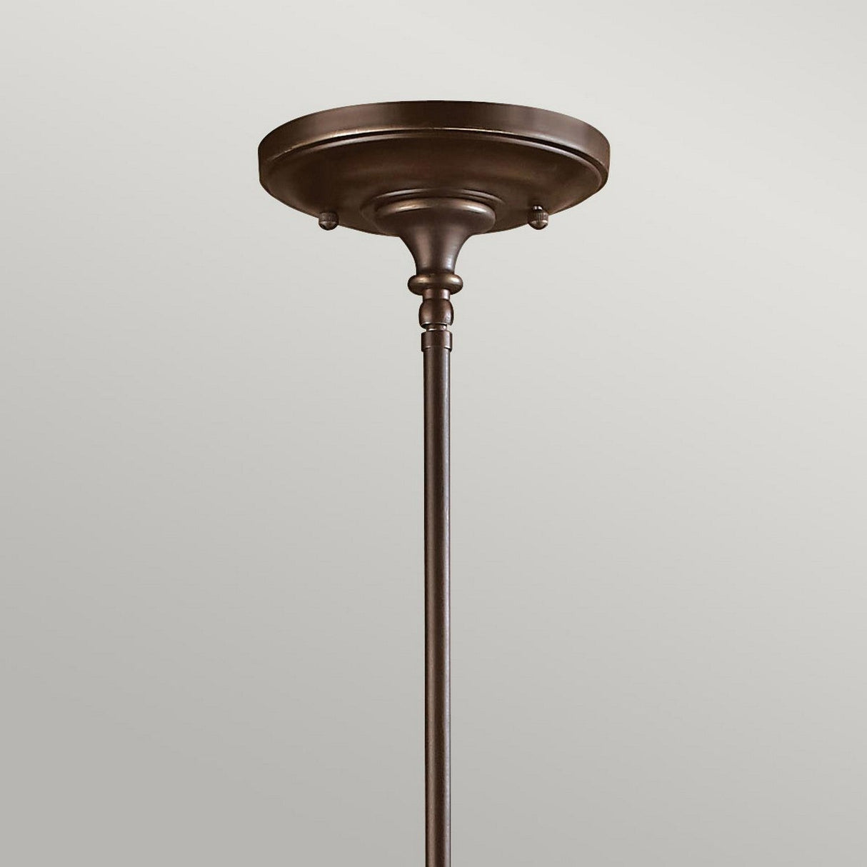 A bronze ceiling canopy with a simple, elegant design against a neutral background, the Mayflower-1 1 Light Mini Pendant in Olde Bronze finish showcases a tapered cylindrical rod extending downward from its rounded base.