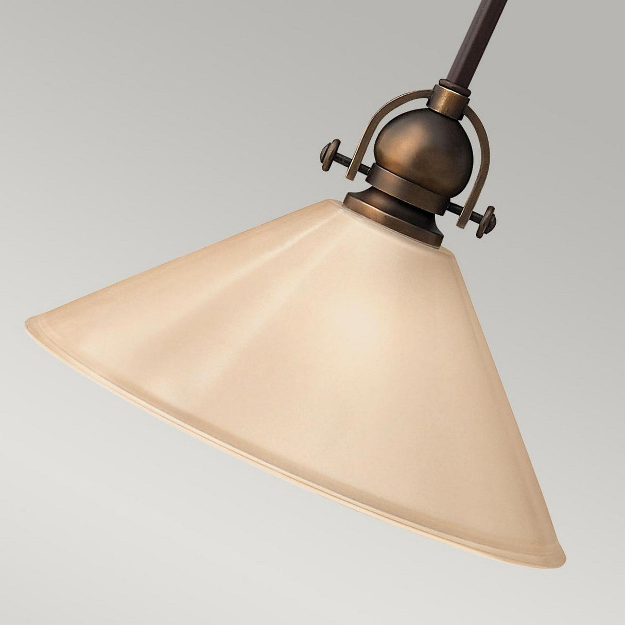 The Mayflower-2 1 Light Mini Pendant in Olde Bronze, featuring a conical beige shade and hanging from a rod, stands against a simple gray background to add vintage-inspired charm.