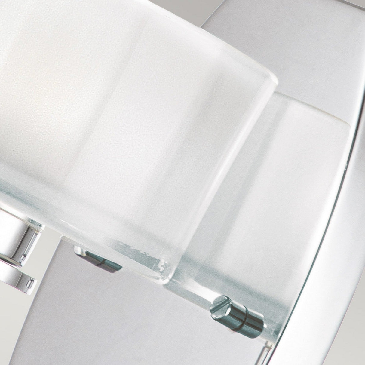 Close-up of a modern, rectangular frosted glass wall sconce with metallic accents on a white background. The Meridian 1 Light Wall Light - Polished Chrome features clean lines and a minimalist design, with its polished chrome finish adding an element of modern elegance.