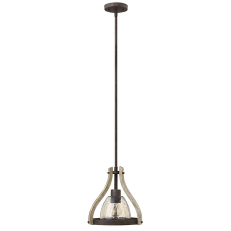 Introducing the Middlefield 1 Light Mini Pendant in Iron Rust, featuring a rustic metal frame with a textured glass shade. This mini pendant hangs from a long rod and showcases curved metal accents with distressed wood elements, offering an industrial yet elegantly vintage charm.
