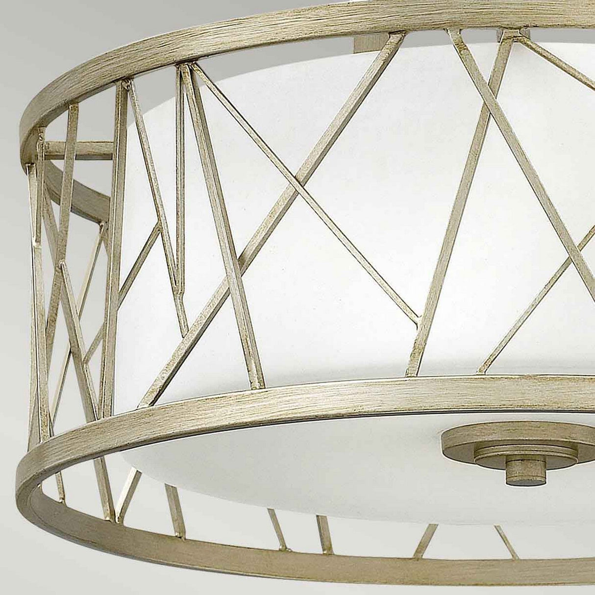 Close-up of the Nest 3 Light Semi Flush - Gold With Linen Glass, exhibiting an organic modern design. It features a gold finish on the metal frame with intersecting lines encasing linen glass, creating a geometric pattern that lends a strikingly contemporary aesthetic.