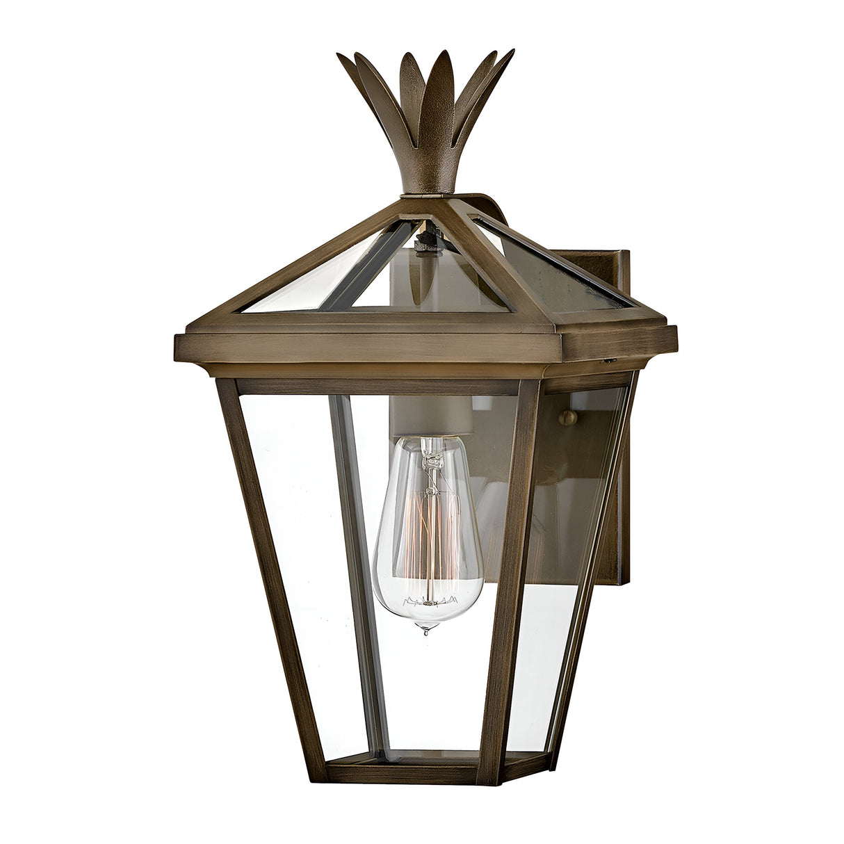 The Palma Outdoor 1 Light Small Wall Lantern in Burnished Bronze showcases a vintage design, with a burnished bronze frame and clear glass panels. It features a single light bulb that casts a warm glow, complemented by a decorative finial adorned with a pineapple motif on the top.