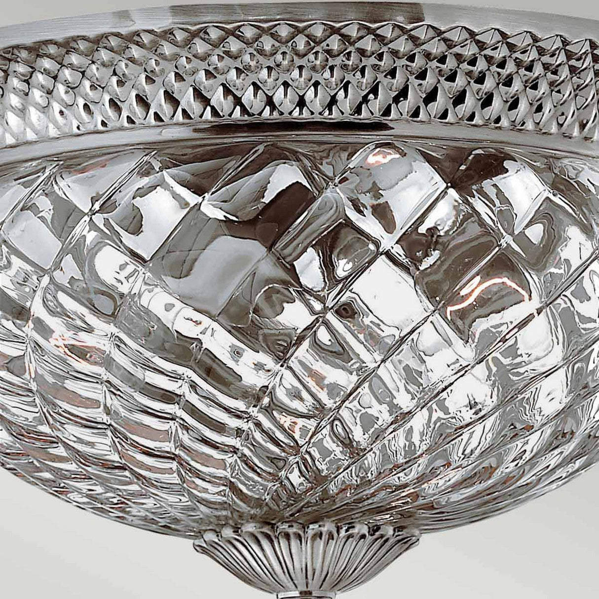 A close-up of the Plantation 3 Light Large Flush ceiling light fixture, featuring a pineapple-shaped clear optic glass design with a silver metal rim. The textured glass surface displays a crisscross pattern, while the rim is crafted in Polished Antique Nickel and showcases an elegant diamond design.