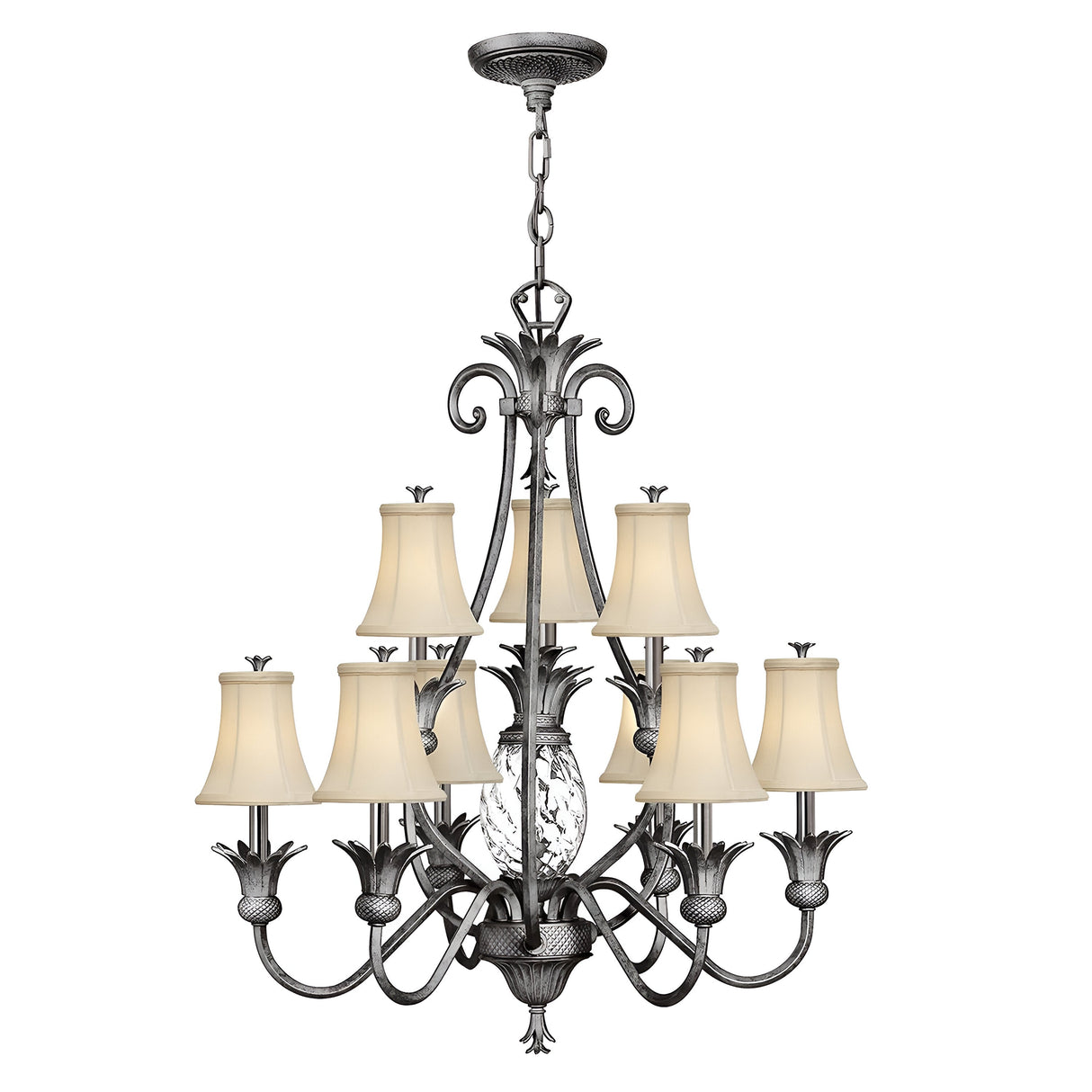 The Plantation 10 Light Chandelier features nine cream lampshades arranged in two tiers and showcases intricate metalwork with curved arms and ornate detailing in polished antique nickel. It is elegantly suspended by a chain.