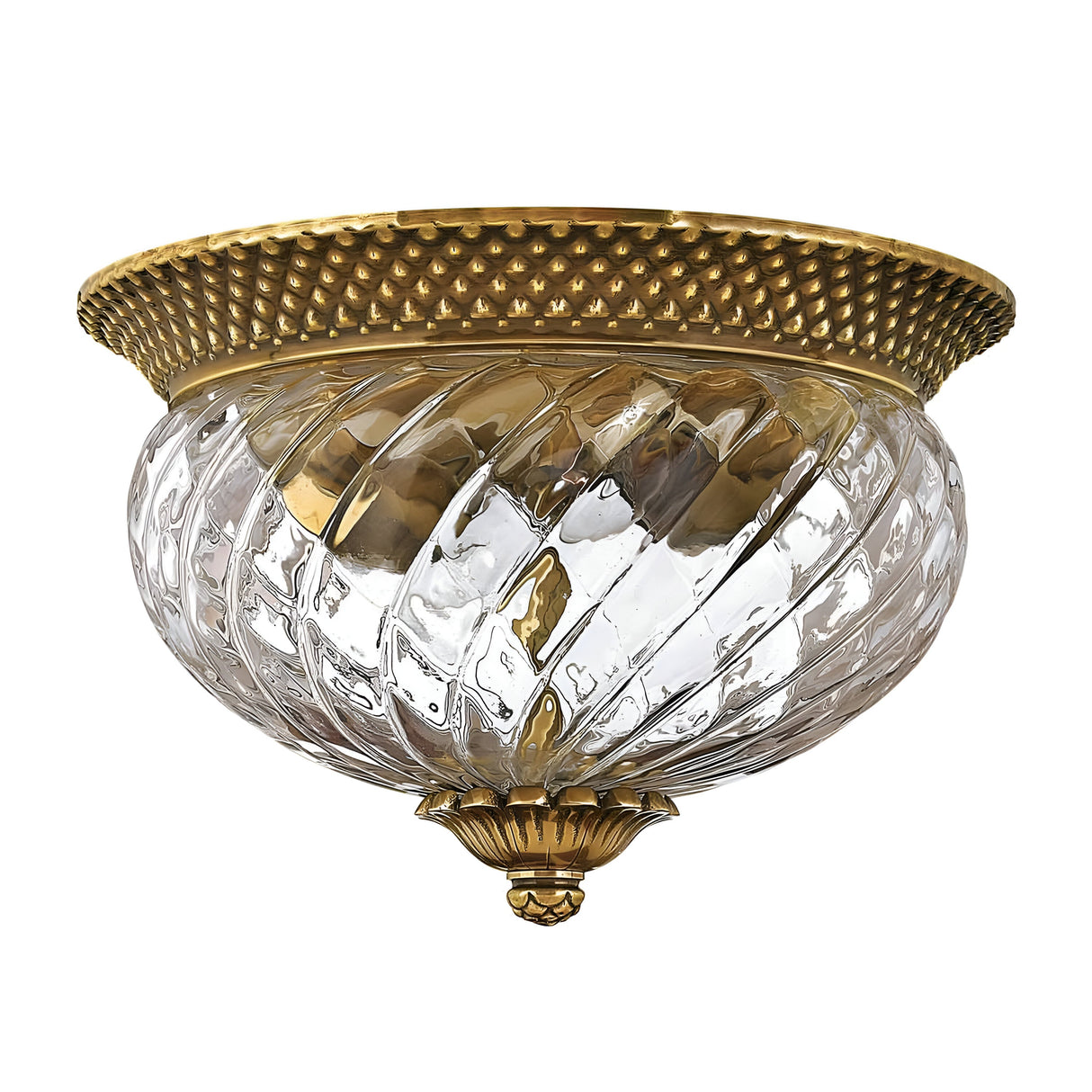 The Plantation 2 Light Flush in Burnished Brass is a vintage-style fixture featuring a burnished brass rim and intricate detailing. Its glass shade boasts a spiral texture and emits a warm, golden glow, reminiscent of a pineapple-shaped design.