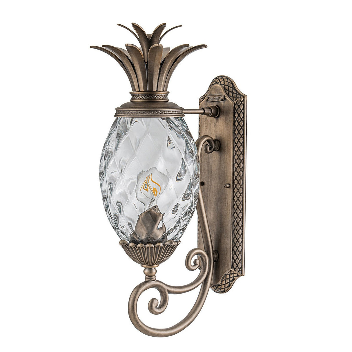 The Plantation Outdoor 1 Light Medium Wall Lantern in Burnished Bronze features an antique-style design with pineapple optic glass. It resembles a pineapple and is mounted on an ornate bracket, making it perfect as an outdoor lantern.