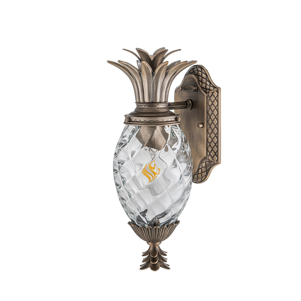 Introducing the Plantation Outdoor 1 Light Small Wall Lantern in Burnished Bronze, featuring a decorative pineapple-shaped sconce crafted from pineapple optic glass with intricate diamond patterns. This outdoor wall lantern includes a flame-like light fixture inside, complemented by an ornate metal base and an elegant crown at the top.