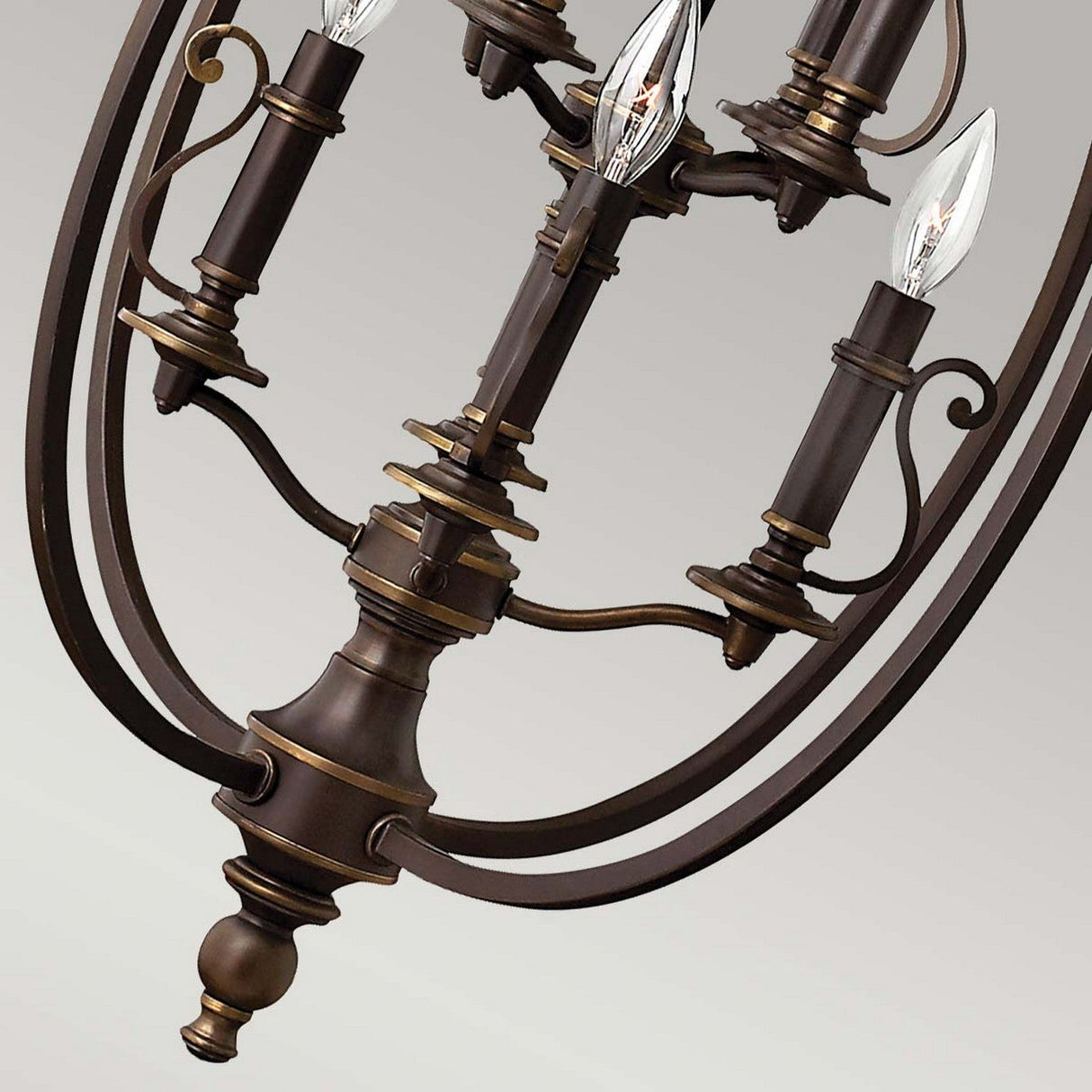 Close-up of the Plymouth 8 Light Chandelier - Bronze, showcasing its elegant design with vintage candle sleeves and a classic candle-style arrangement. It features multiple arms with elongated bulbs that mimic candle flames, while its ornate details and graceful curves contribute to a sophisticated and timeless look.